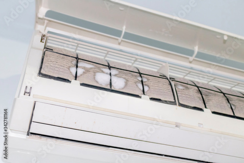 Iced and dusted air conditioner's filter before cleaning by mechanic