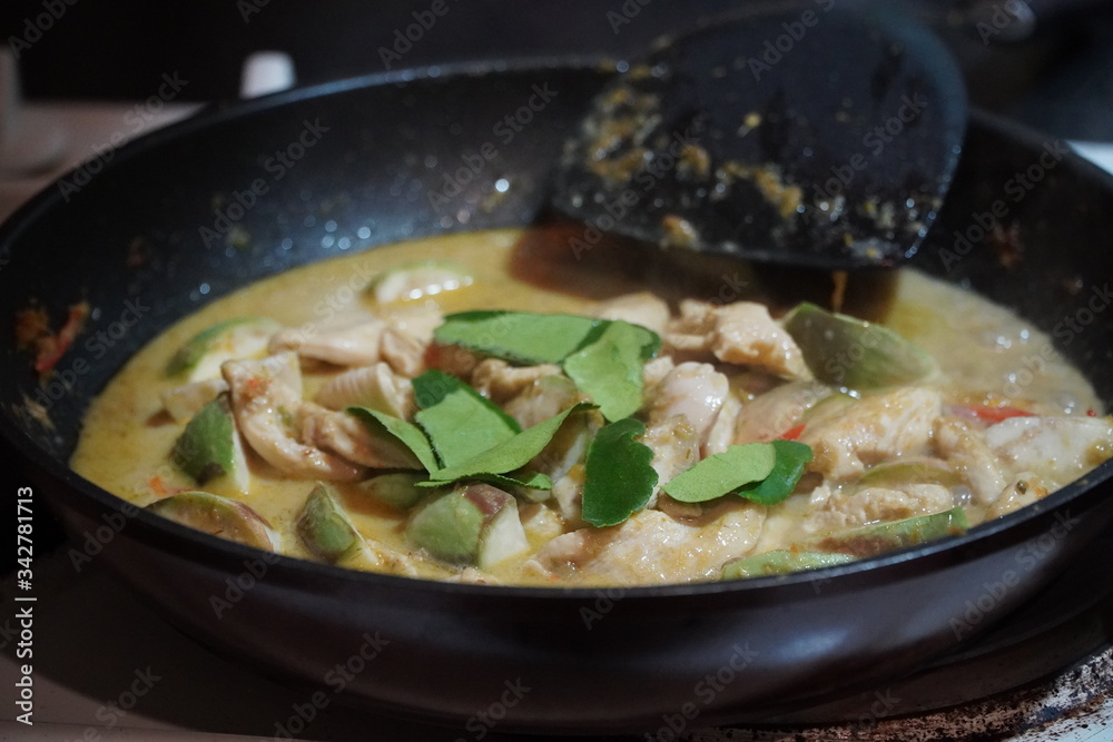 Spicy chicken in a sauce of coconut milk close-up in a frying pan,Stay at home
