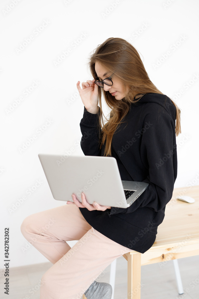 Woman with a laptop computer. Freelancer, distant work, work at home, online training Woman with a laptop computer. Freelancer, distant work, work at home, online training