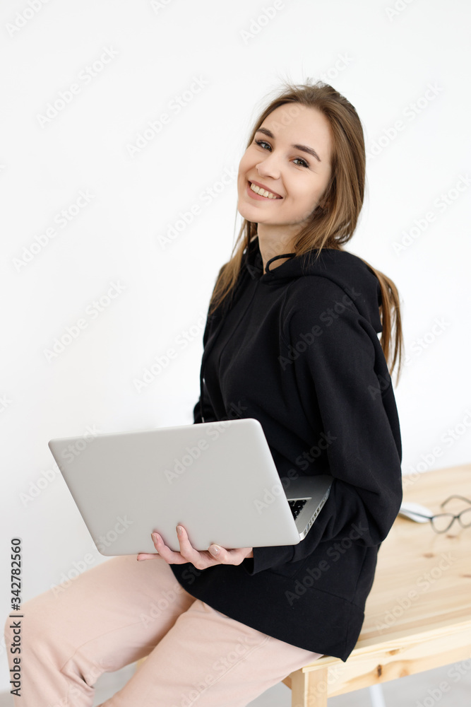 Woman with a laptop computer. Freelancer, distant work, work at home, online training Woman with a laptop computer. Freelancer, distant work, work at home, online training
