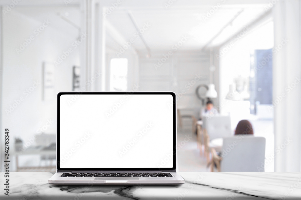 Laptop computer with blank white screen on marble table with modern workplace background , Social distancing Concept Laptop computer with blank white screen on marble table with modern workplace background , Social distancing Concept