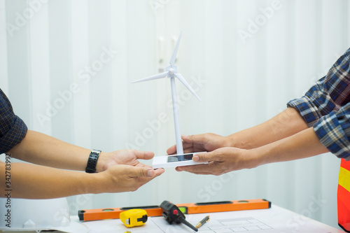Engineers jointly design wind turbine models for power generation.