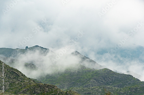 thick clouds over rock ridge, bad weather and waiting for rain in  mountains © Koirill