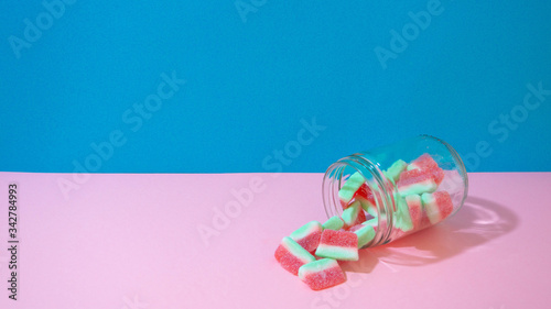 Glass with candy watermelons on the table