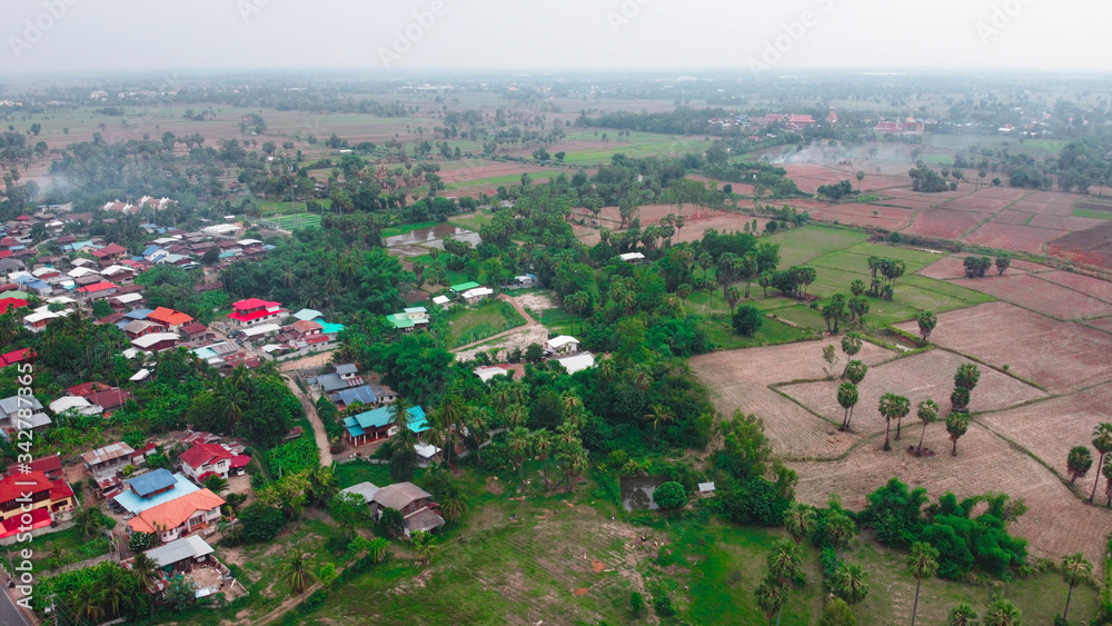 Aerial view of green fields and farmlands in rural Thailand.