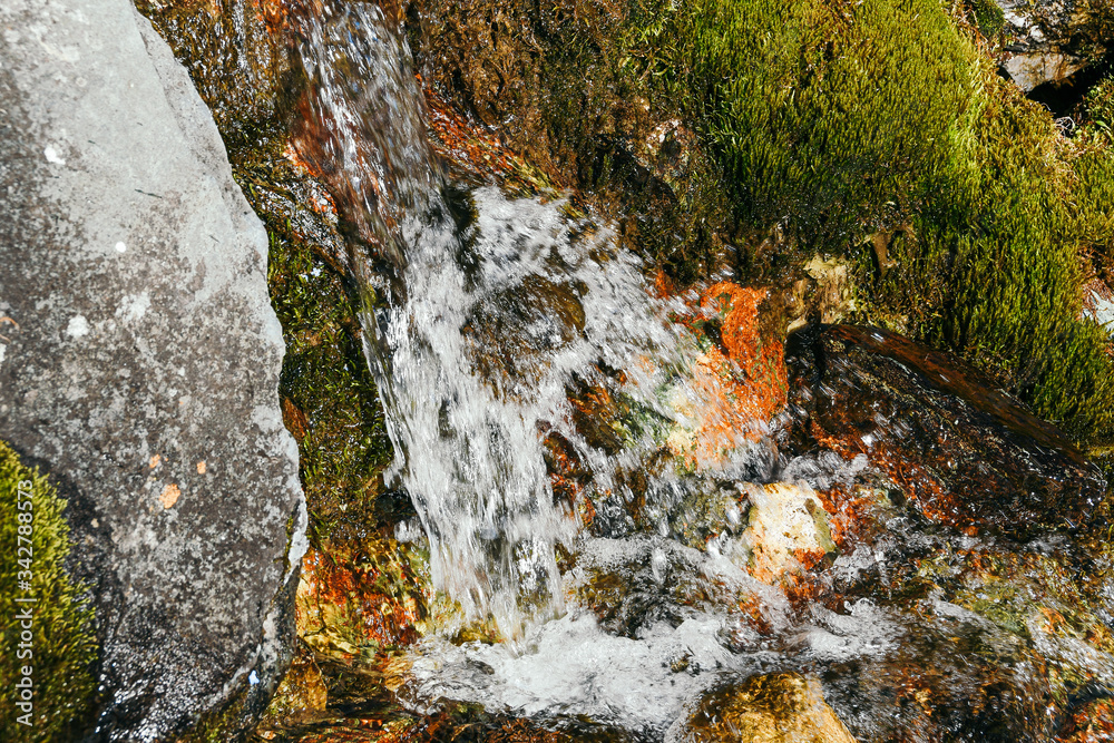 rapid stream with spray, river in mountain valley rapid stream with spray, river in mountain valley