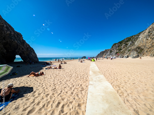 Adraga beach landscape and rock arch, Atlantic ocean. Almocageme, Sintra, Portugal. photo