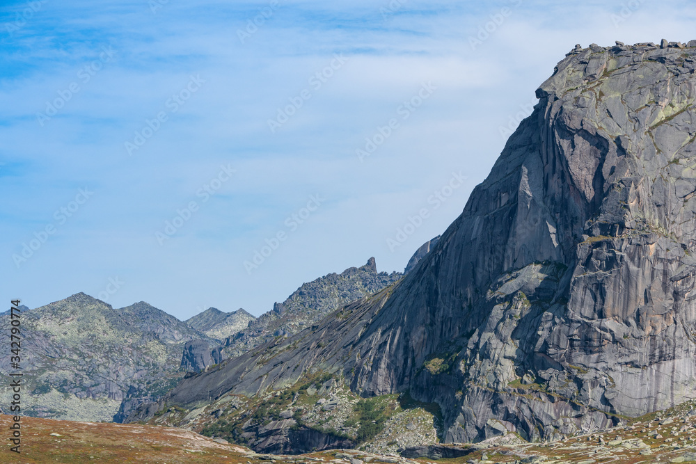 silhouette of mountain range on horizon, rocks and cliffs in mountain valley, tourist trip to mountains