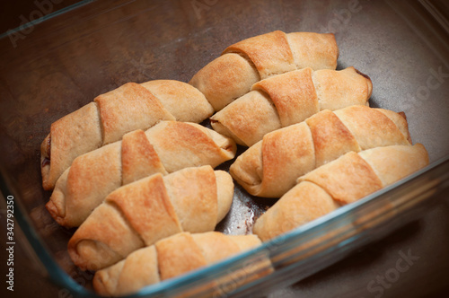 Homemade pastry. The rugelach with jam in a grass container. Homemade holiday cookie. photo