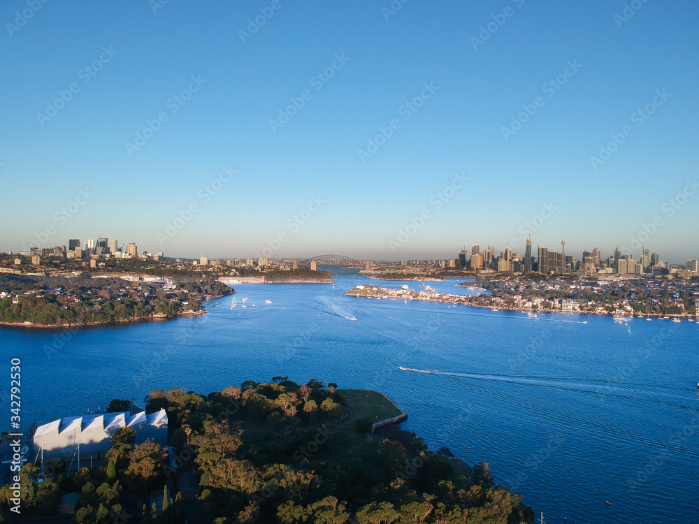 Panoramic drone aerial view over Sydney harbour on a cloudy sunset showing the nice colours of the harbour foreshore Panoramic drone aerial view over Sydney harbour on a cloudy sunset showing the nice colours of the harbour foreshore