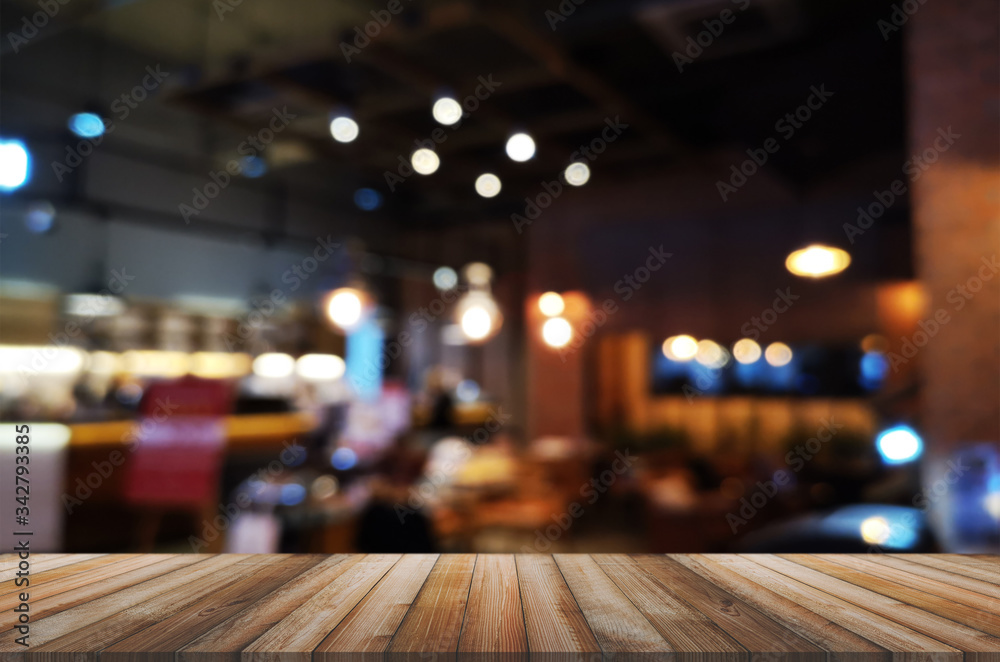wooden table with abstract blurred background resturant lights used for display montage products mock up design.
