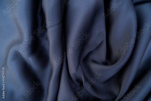 Blue color fabric. Dark blue silk fabric background. Tencel blue sheet. photo