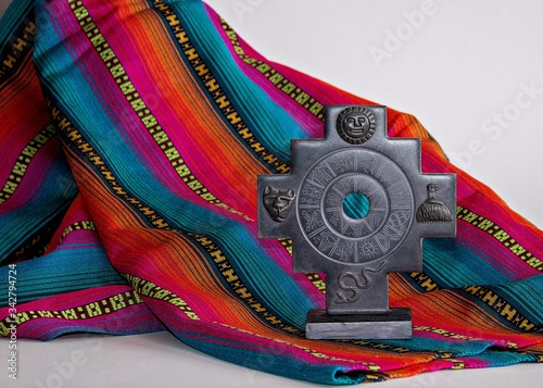 Inca cross chakana and fabric with Inca design patterns photo