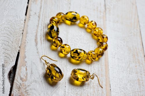 Bright yellow faux amber bracelet and earrings. Background for jewelry and women's jewelry.