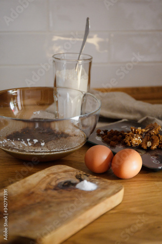 
The ingredients for making muffins lie on a wooden tabletop. photo with place for text