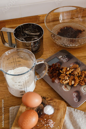 
The ingredients for making muffins lie on a wooden tabletop. photo with place for text