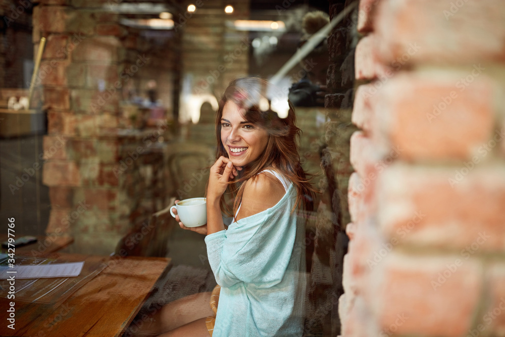 Woman sitting alone at cafe and looking at window. Woman sitting alone at cafe and looking at window.
