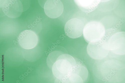 Defocused abstract background green lights. The theme of ecology, healthy lifestyle. Medicine, science, technology. Rod designer abstraction for writing of the text. Soft, light, abstract, color.