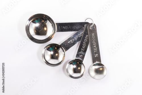 Stainless steel measuring spoons isolated on white background