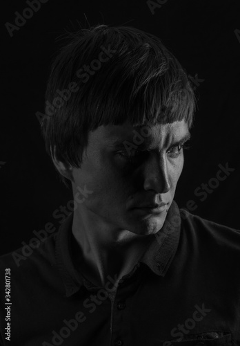 Black and white male portrait in low-key light