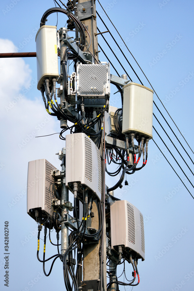 Telecommunication tower of 4G and 5G cellular. Macro Base Station. Wireless Communication Antenna Transmitter. Telecommunication tower with antennas against blue sky background. Telecommunication tower of 4G and 5G cellular. Macro Base Station. Wireless Communication Antenna Transmitter. Telecommunication tower with antennas against blue sky background.