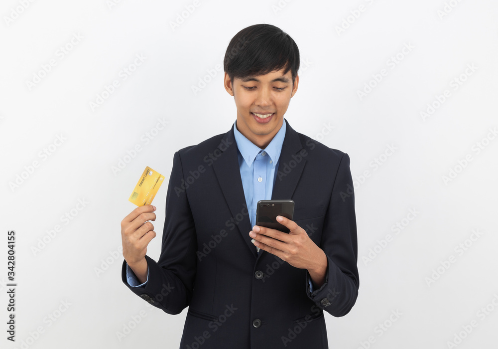 Happy smiling asian businessman in black suit using smartphone and holding credit card for online shopping, E-commerce, Internet banking. Happy smiling asian businessman in black suit using smartphone and holding credit card for online shopping, E-commerce, Internet banking.