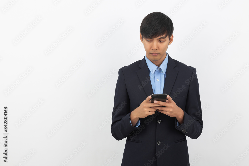 Young asian businessman in black suit using smartphone isolated on white background, Online shopping, Remotely working. Young asian businessman in black suit using smartphone isolated on white background, Online shopping, Remotely working.