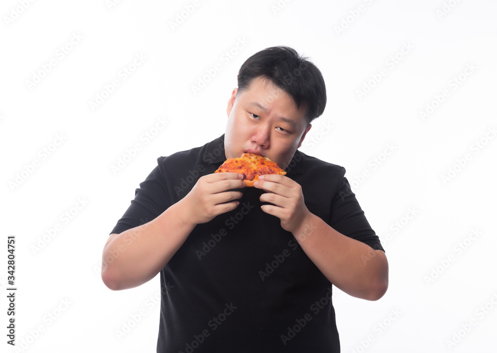 Happy young asian fat man in black polo shirt eating pizza isolated over white background.