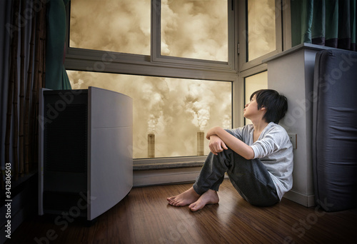 Young Asian boy wearing face mask at home to protect against air pollution