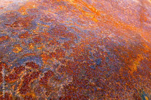 Textures of rusted metal for backgrounds and wallpaper. Blue dried mudscapes and the colorful rusted metal. Oranges, Blues, Greens, Vintage feel, decay. photo