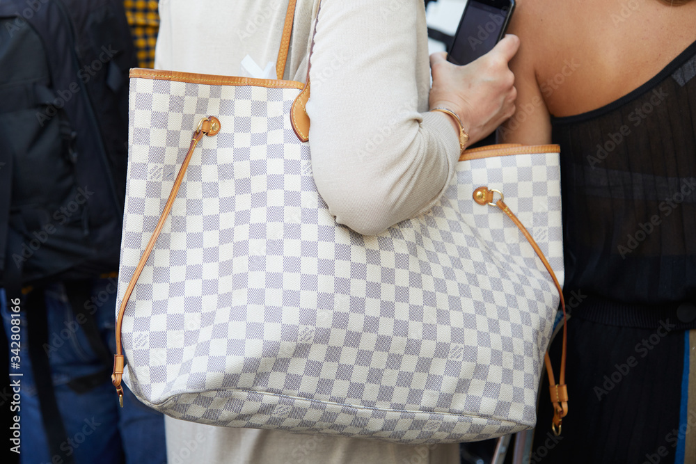Woman with gray and white checkered Louis Vuitton bag on June 15