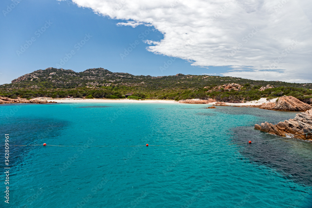 Panoramic view of the pink granite rock formations and the clear and transparent waters in the Maddalena archipelago in Sardinia, Italy. Panoramic view of the pink granite rock formations and the clear and transparent waters in the Maddalena archipelago in Sardinia, Italy.