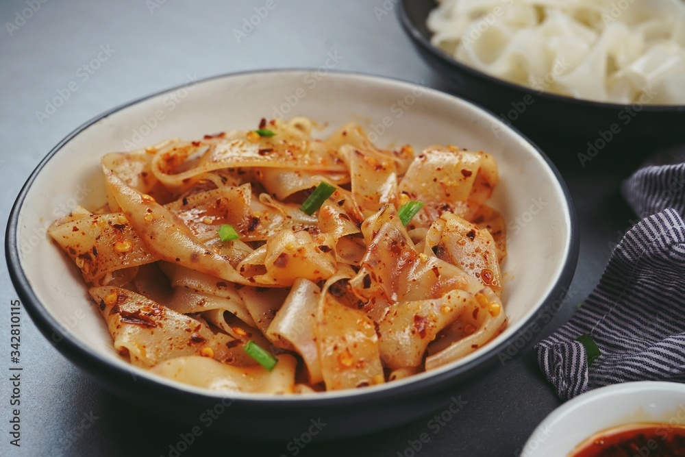 Homemade Rice noodles in chilli oil, selective focus Homemade Rice noodles in chilli oil, selective focus