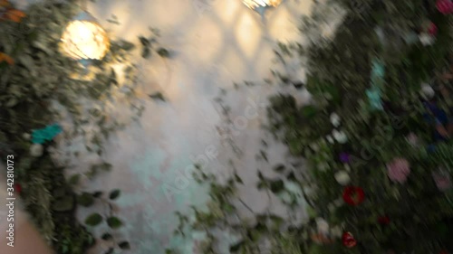 brutal man picked up a bitten red apple from the floor and throws it behind him, sad, worried. Against the background of foliage, a man in a suit is afraid, worries