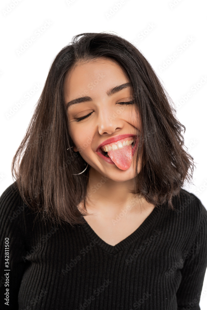Young woman showing tongue isolated on white background. Young woman showing tongue isolated on white background.