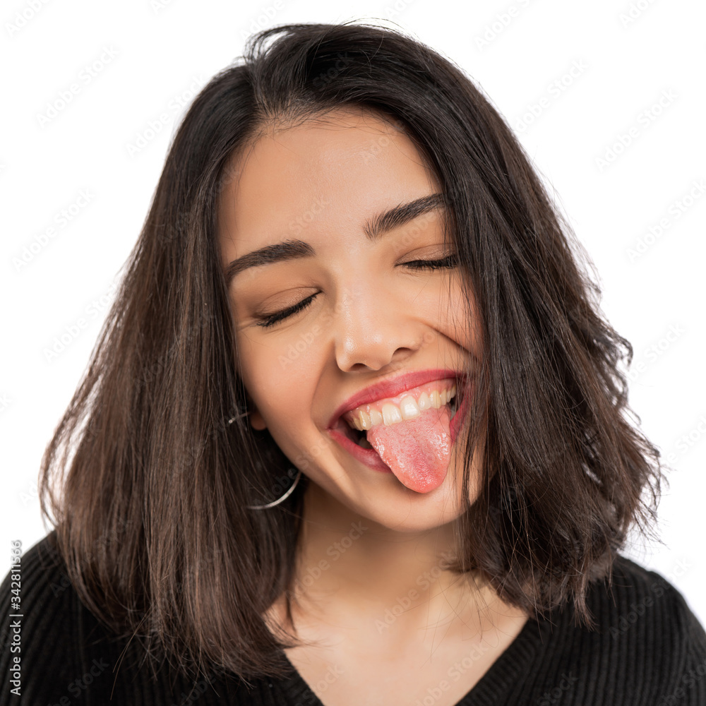 Young woman showing tongue isolated on white background. Young woman showing tongue isolated on white background.
