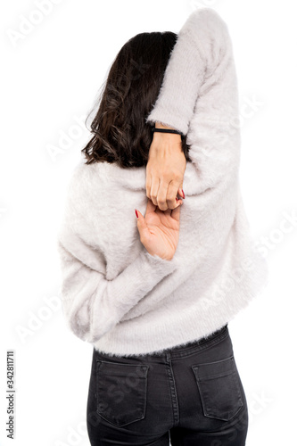 Young woman making hands lock behind the back on white background
