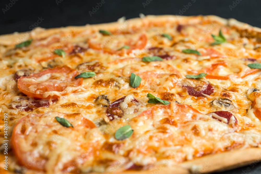 pizza on a plate with black background pizza on a plate with black background