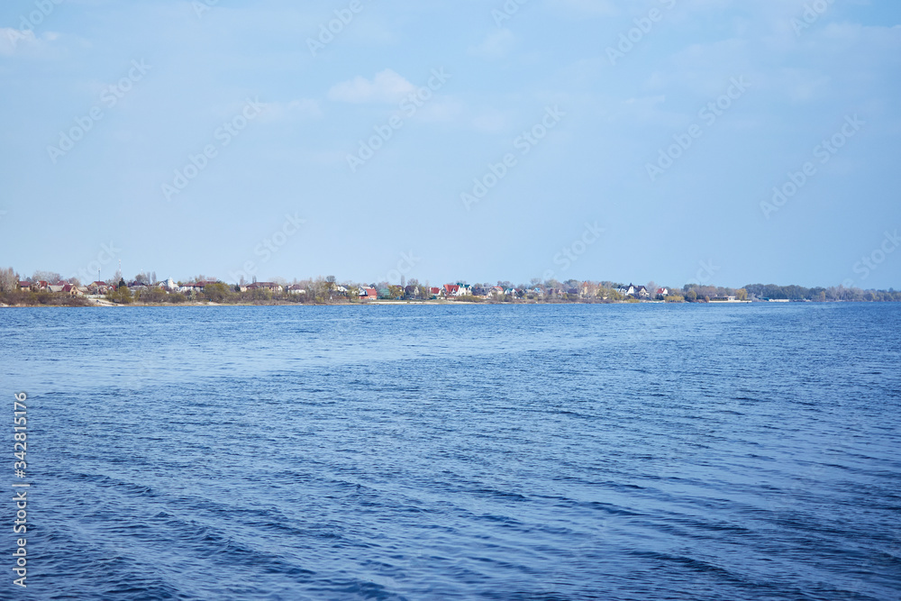 expanse of river water with houses on the shore. expanse of river water with houses on the shore.