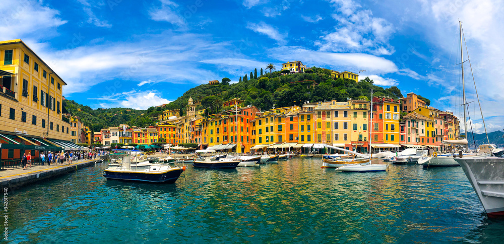 Stunning view of boats and yachts moored in the harbor of Portofino, one of the world's most beautiful seaside towns on the Italian Riviera. Mediterranean landscape of yacht-filled harbor. ITALY