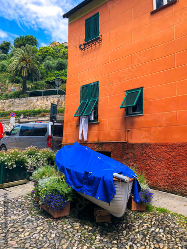 Lonely boat standing on one of the streets in Portofino near colorful building, Italian Riviera, Italy.