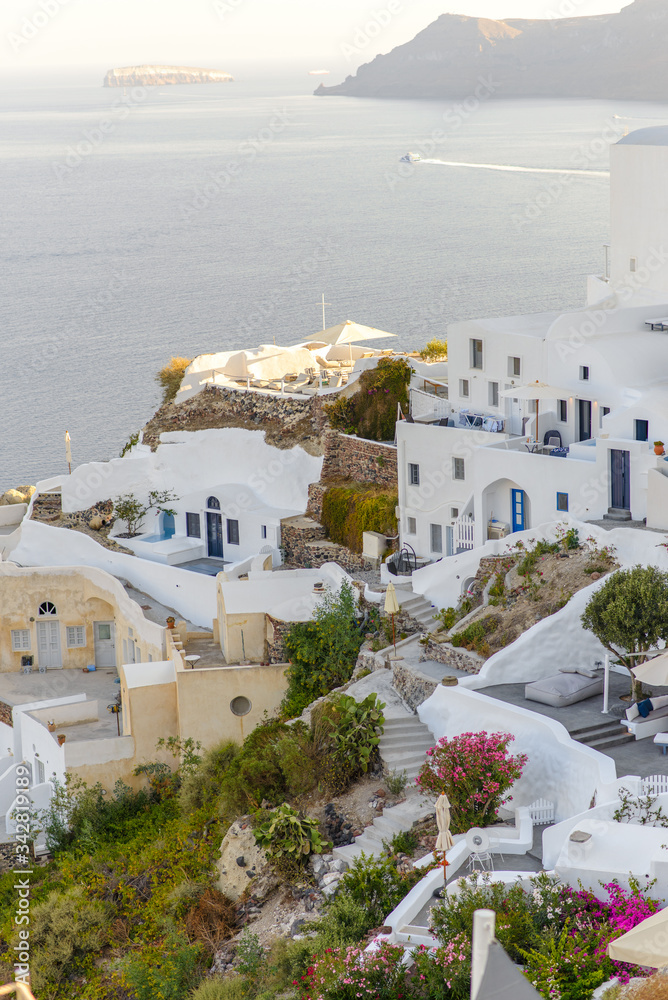 Fototapeta premium Panorama of the city during sunset in the village of Oia, Santorini.