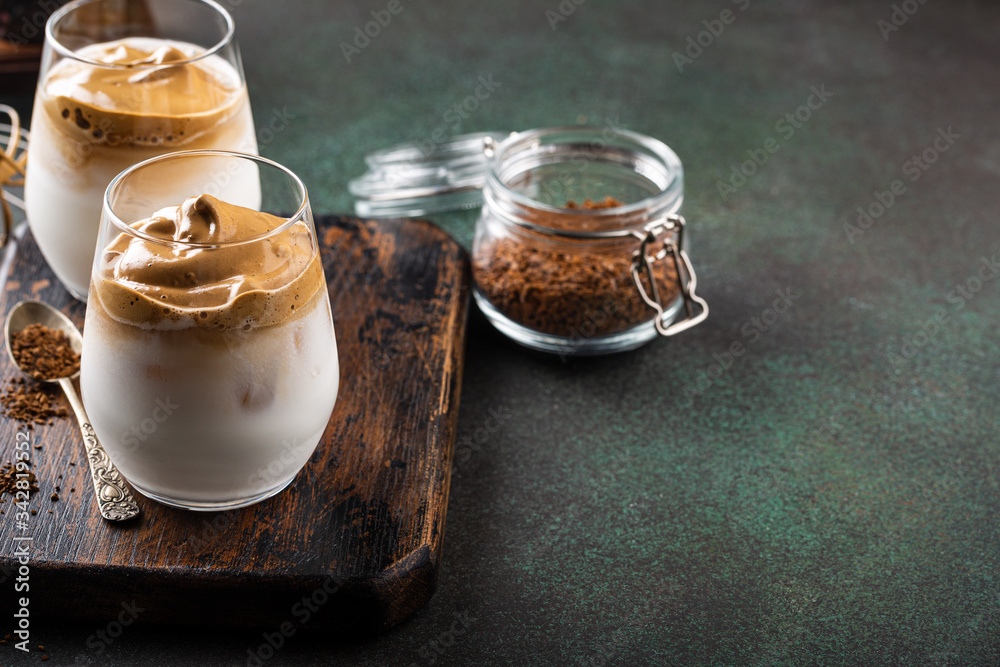 Dalgona coffee in glass cup. Korean trendy drink from instant coffee, milk and ice. Summer beverage concept with copy space. Dalgona coffee in glass cup. Korean trendy drink from instant coffee, milk and ice. Summer beverage concept with copy space.
