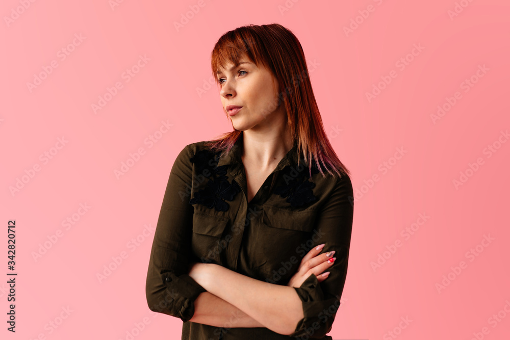 Strict serios fashion business woman with hands crossed looking attractive isolated on pink background Strict serios fashion business woman with hands crossed looking attractive isolated on pink background