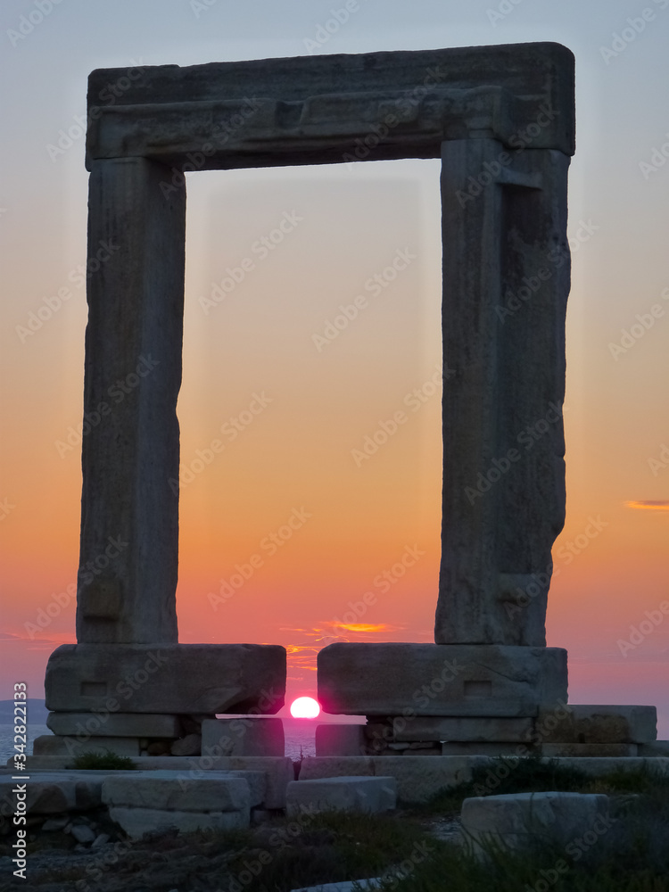 Sunset on Portara - ruins of ancient temple of Delian Apollo on Naxos island, Cyclades, Greece