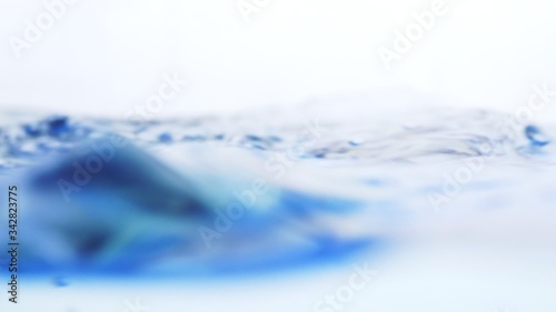 Fotografia Soft blur focus of Abstract water splash surface filling the frame with the water drop and waving liquid with an air bubble on a white background and copy space