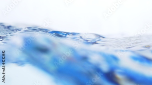Soft blur focus of Abstract water splash surface filling the frame with the water drop and waving liquid with an air bubble on a white background and copy space.