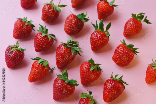 Top view of pile of strawberries on white surface with blank copy space
