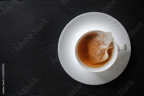 Tea bags in a white coffee mug  Tea bags release billions of micro-plastics and nano-plastics into tea 