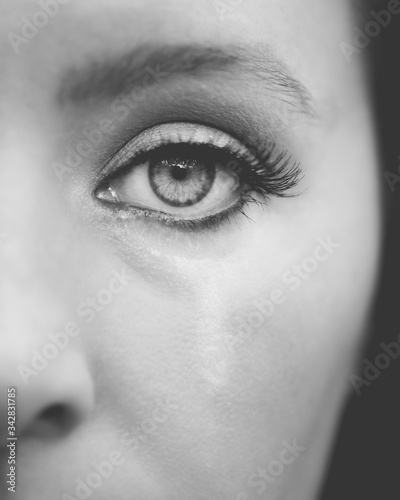 close up of a female eye crying black and white 
